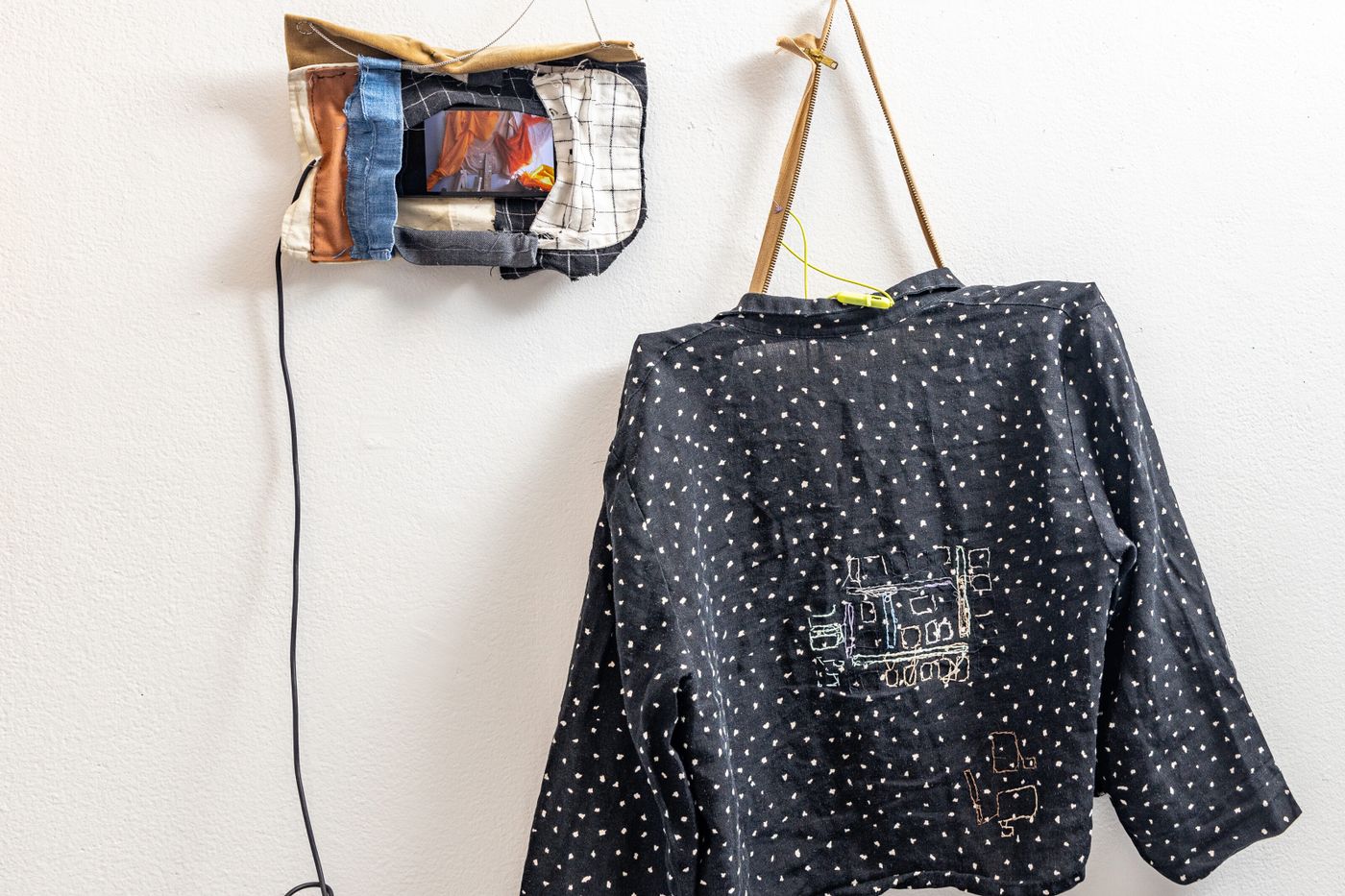 Anne Mailey with collaborators Katherine Yaochen Du and Goda Trakumaite, Conversations Between Cats and Clothes (detail), 2020-2022. Fabric, found objects, cellphones, video, stop motion animations, clothing, thread; 76 x 82 in. Video 4 min, 55 sec. Photo: Meghan Olson.