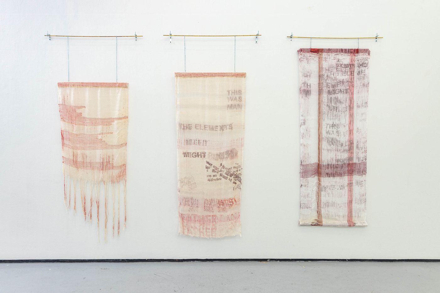 left to right: Redacted Stanzas, THE ELEMENTS MIGHT STAND UP, THE ELEMENTS MIGHT, 2022. Woven on rigid heddle loom with dye and leno-weave; 25 x 62 in., 25.5 x 62.5 in., 26 x 67 in. Photo: Meghan Olson.