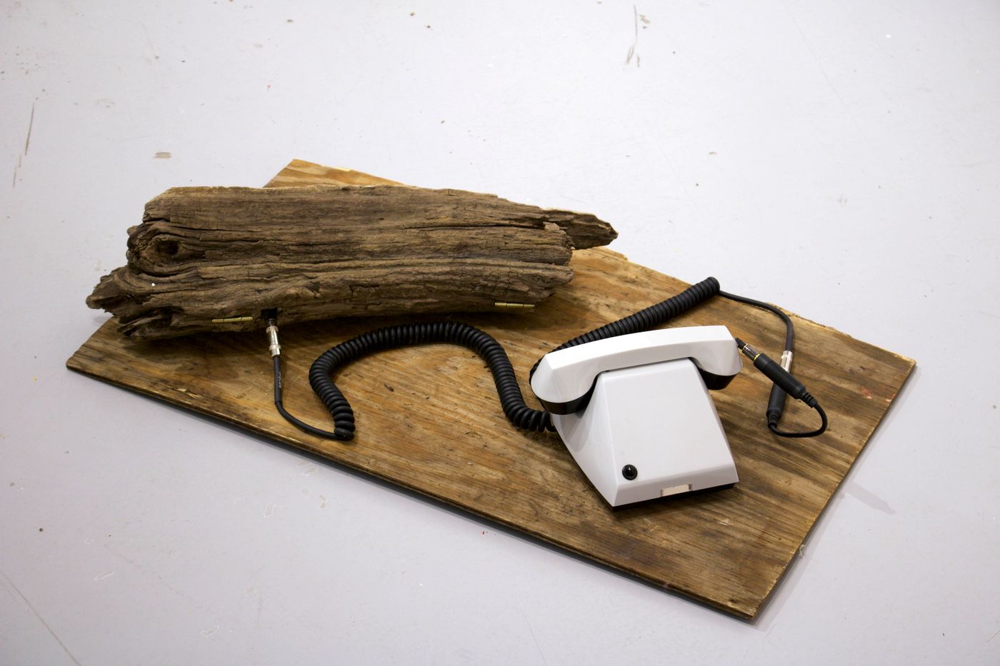 Driftwood Telephone (Device for Mediation), 2022. Soviet-era dial-less telephone, speaker, field recorder, driftwood, found plywood, 1/4 inch instrument cable; approx. 25 x 31 x 10 in.